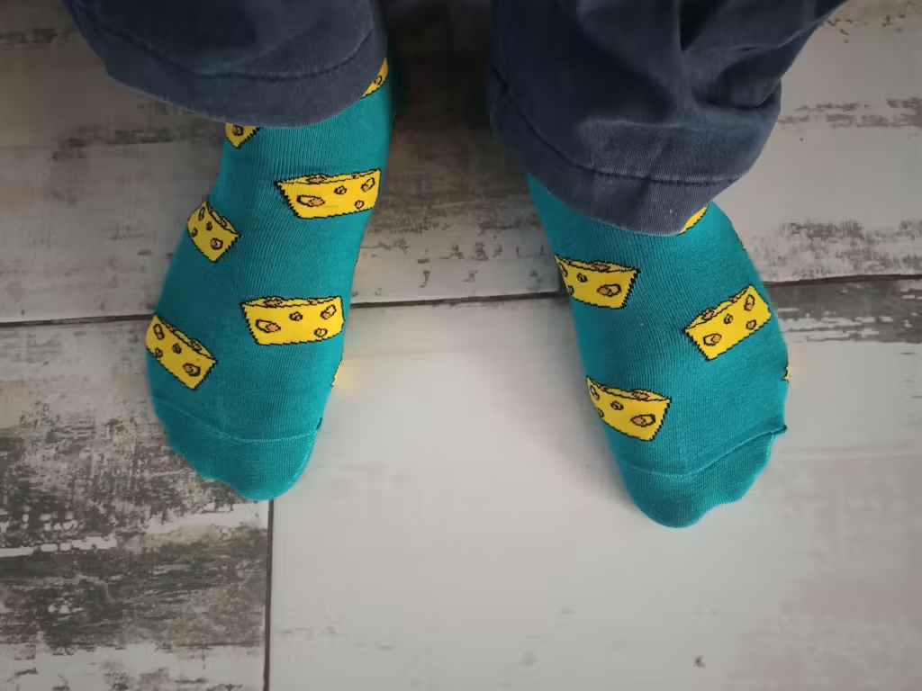 Customer wearing Jumplings teal cheese pattern ankle socks